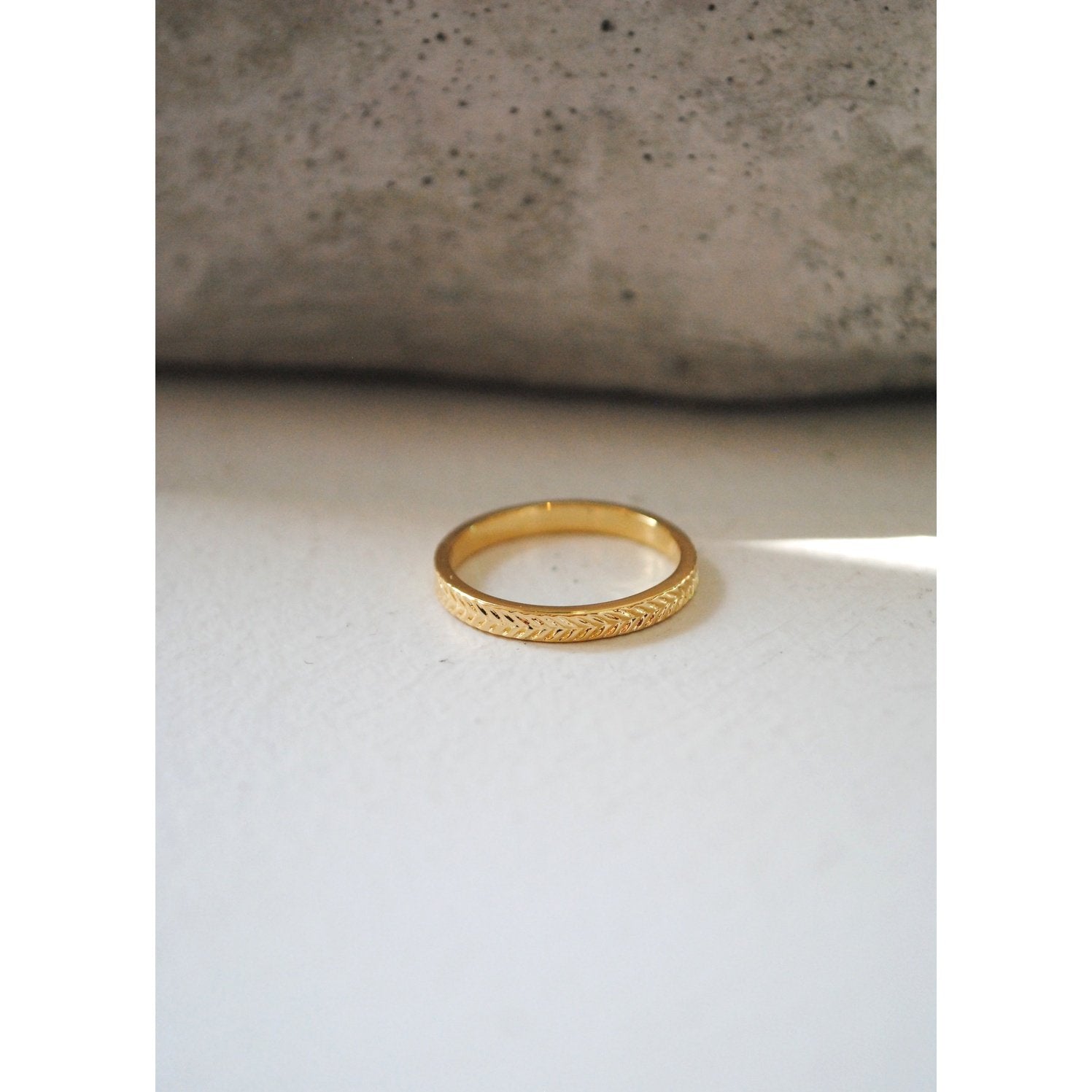 Ring with flat band and braided textured design
