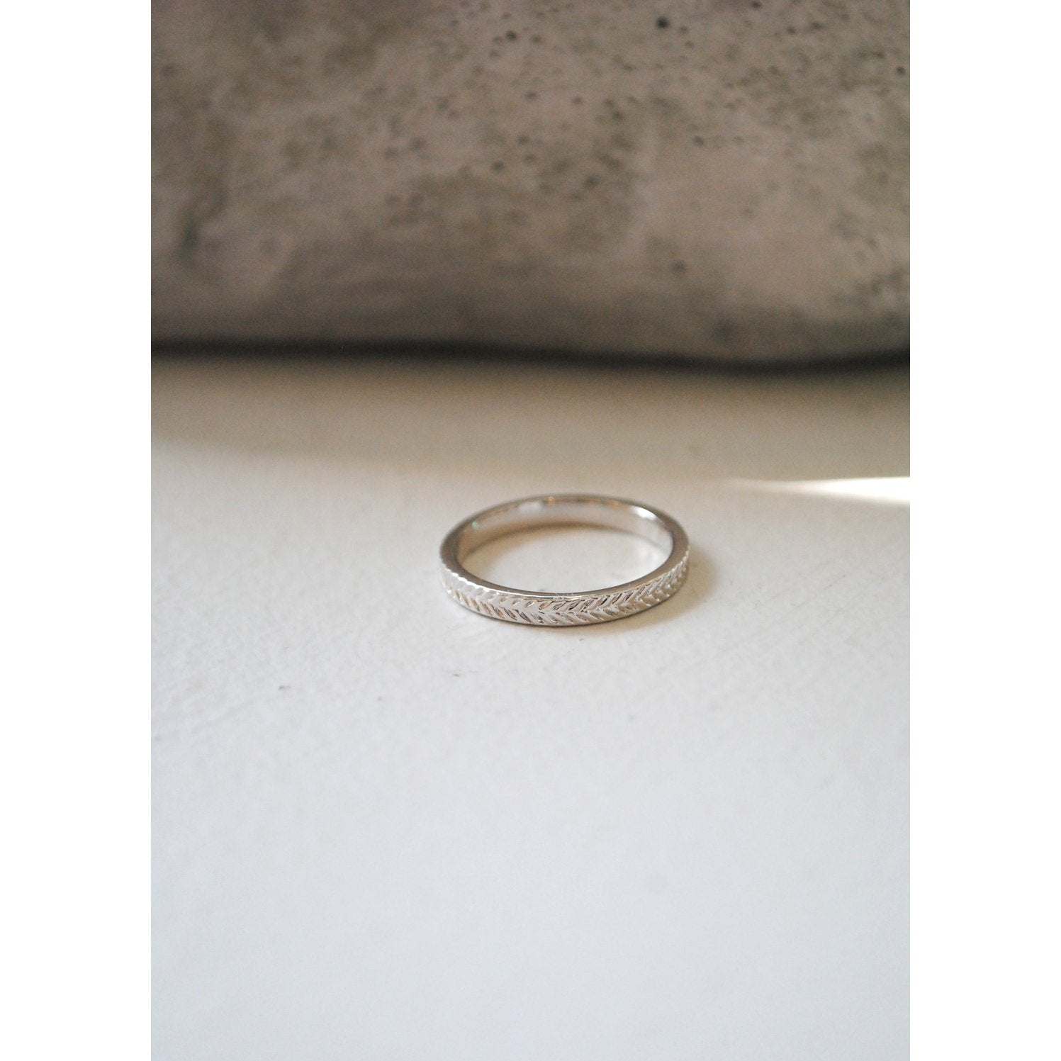 Ring with flat band and braided textured design